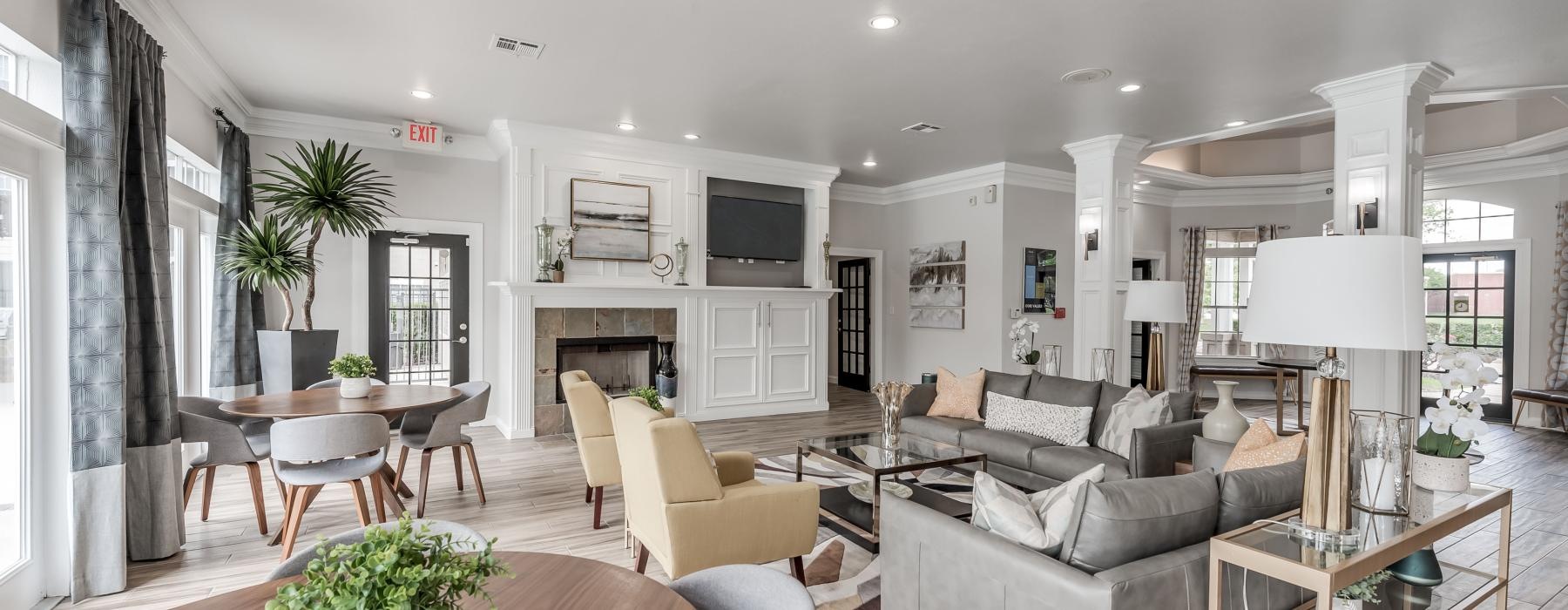 a club house with a large table tv and chairs