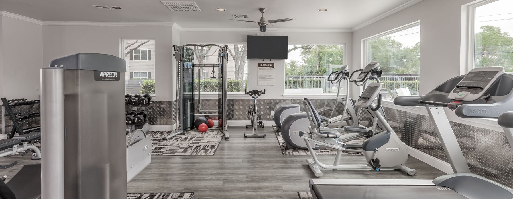 fitness center with workout equipment and weights