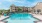 a pool with a building behind it
