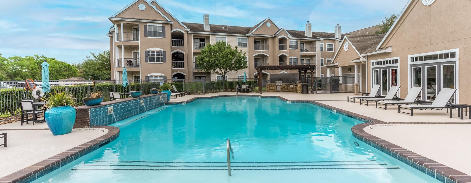 a pool with a building behind it