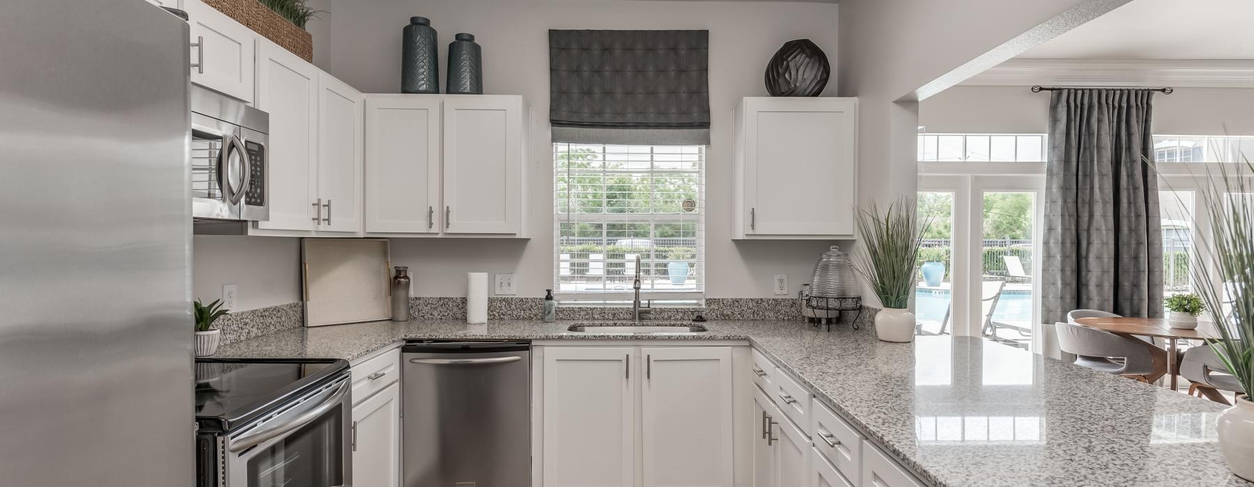 a kitchen with white cabinets