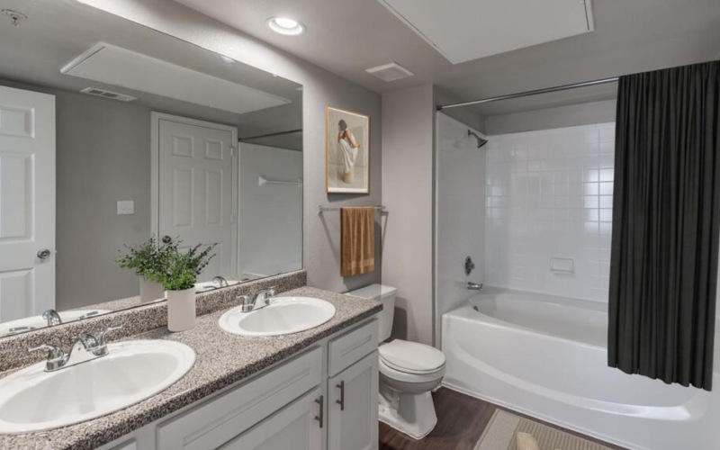 a bathroom with a mirror tub sink and toilet