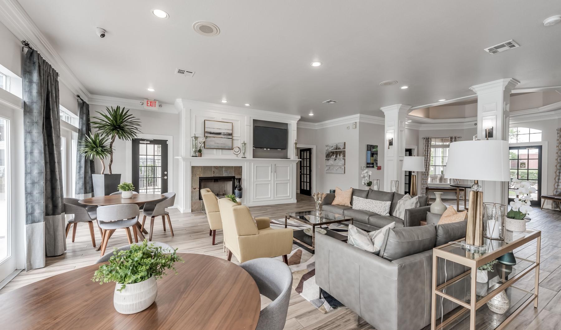 a club house with a large table tv and chairs